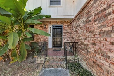 View of exterior entry featuring brick siding