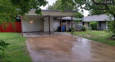 Back of property featuring an attached carport an