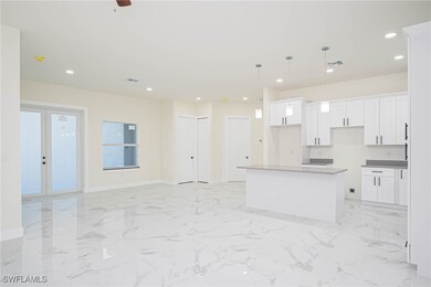 Kitchen featuring white cabinetry, ceiling fan, pe