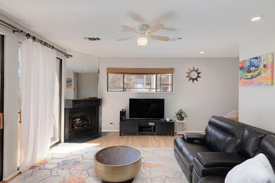Living area featuring a fireplace with flush hear