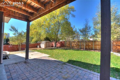 View of patio with a storage shed