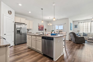 Kitchen featuring a sink, open floor plan, light s