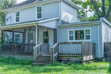View of front facade with a porch and a front lawn