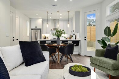 Living area with recessed lighting, visible vents
