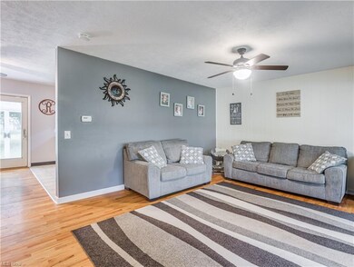 Enter into the foyer, which opens to a hardwood li