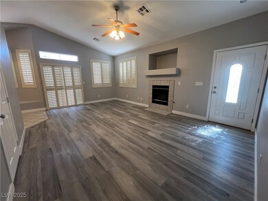Unfurnished living room with a ceiling fan, a fire