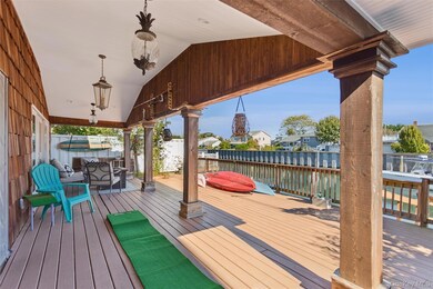 Deck featuring a water view, a residential view, and outdoor dining space