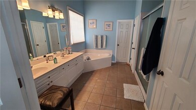 Bathroom with double vanity, tile patterned floors