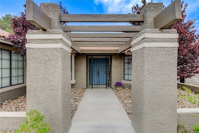 View of exterior entry with a pergola and stucco s