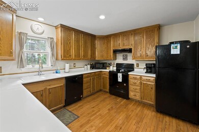 Charming and efficient, the kitchen includes natural wood cabinetry, solid-surface counters, and all appliances—ready for whatever the day brings.