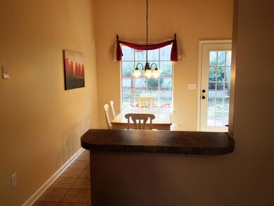 This breakfast bar overlooks the eat-in kitchen an