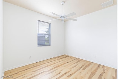 Unfurnished room with wood finished floors and a ceiling fan