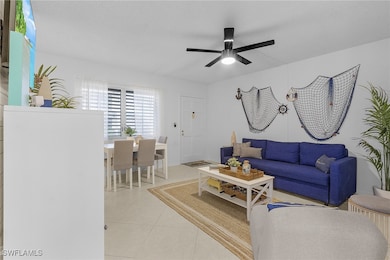 Living room with light tile patterned floors and c