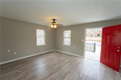 Unfurnished room with ceiling fan, a textured ceil