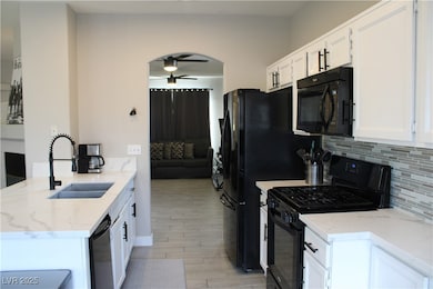 Kitchen with light wood-style floors, ceiling fan,