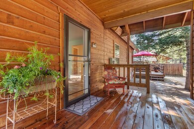 Covered front patio under breezeway to garage