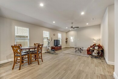 Dining space featuring light hardwood / wood-style floors, ceiling fan, and vaulted ceiling