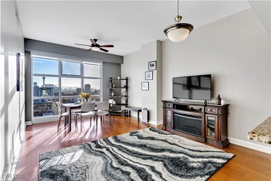 Living area featuring a ceiling fan, wood finished