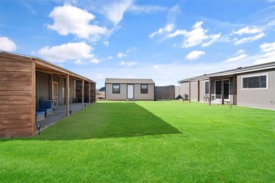 To the right is the back of the home, straight ahead the she-shed or man cave, which is fully insulated and climate controlled., To the left is the party house.