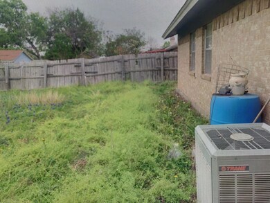 View of yard with fence and central AC unit