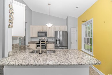 Kitchen with built in desk, lofted ceiling, kitche
