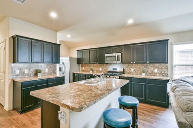 Large, Open kitchen area. Lots of cabinets. Functional island. Great for entertaining.