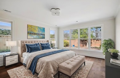 Bedroom with multiple windows, crown molding, and 