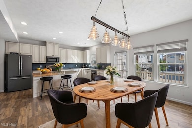   *Virtually Staged Dining space featuring a textured ceiling and dark hardwood / wood-style floors