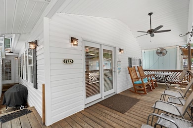 Wooden terrace featuring grilling area and a ceili