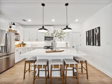 Kitchen with pendant lighting and floating shelves