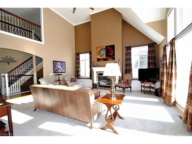 Grand but comfortable living room offers cathedral