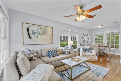 Living room featuring a ceiling fan, visible vent