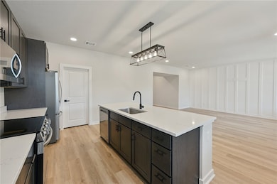 Kitchen with a sink, appliances with stainless ste