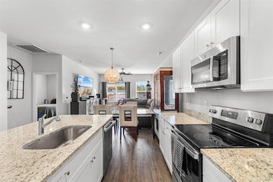 Kitchen with light stone countertops, stainless st