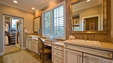 Lovely master bath featuring his and her sinks with large walk-in closet- as shown in model