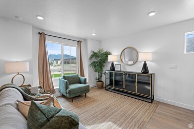 Sitting room with light wood-style flooring, recessed lighting, and a mountain view