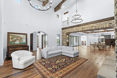 Living room with a towering ceiling, wood-type flo