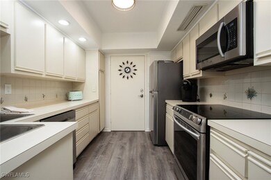 Kitchen with tasteful backsplash, stainless steel