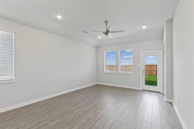 Unfurnished room featuring ceiling fan, light woo