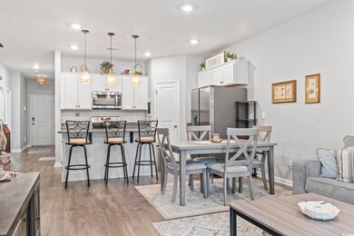 Dining space with dark wood-style flooring and recessed lighting