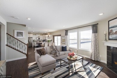 The view from the family room through the dining area to the kitchen. The entire area feels open and welcoming. The spindled staircase makes a statement in the room. Front entrance and flex room are just beyond to the left.