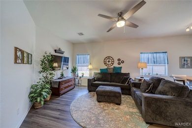 Living room with visible vents, dark wood finished