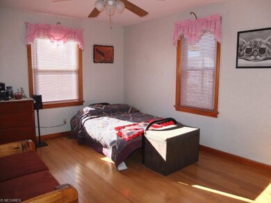 Bedroom 2 on the main level with hardwood floor.