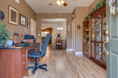 Enter into your foyer looking through to the remainder of the downstairs, garage door located to the left.