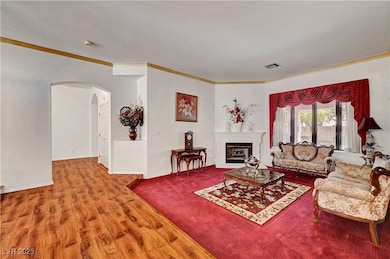 Living room with arched walkways, wood finished fl