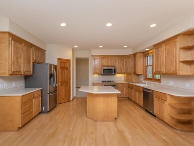 Kitchen features hardwood floor, stainless steel a