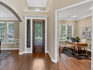 Step inside the extended soaring foyer and be greeted by rich hardwood flooring! Located off of the entry, opposite of each other, you'll find  a stunning formal dining room and a private executive study w/ glass French doors.