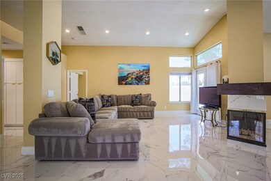 Living room featuring marble finish floor, a firep