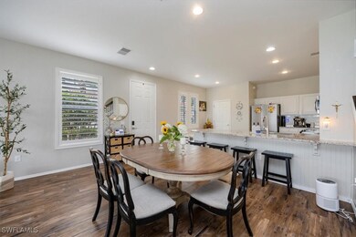 Dining room with dark wood-style flooring, plenty