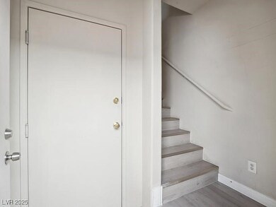 Stairs with wood finished floors and baseboards